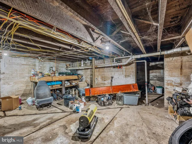 a view of a house with a small yard and large trees