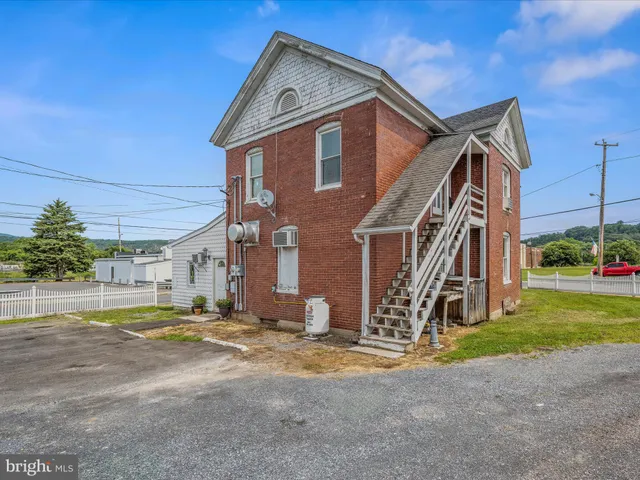 an aerial view of a house with a garden and lake view