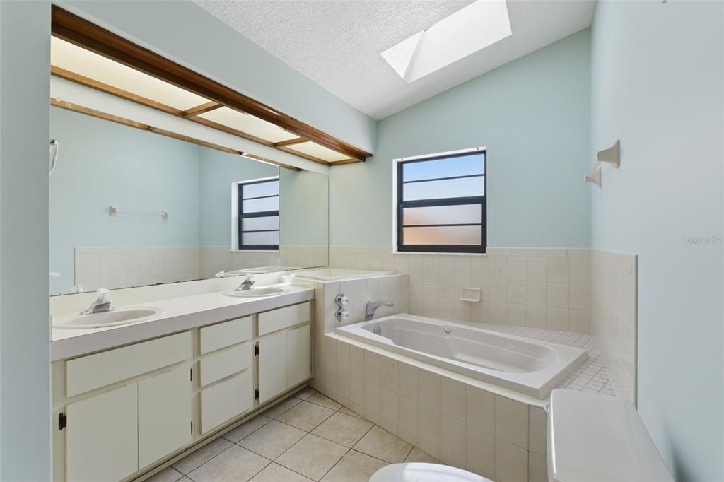 4966 Keysville Avenue Spring Hill, FL 34608 - Photo 28 of 48 a bathroom with a tub sink and mirror