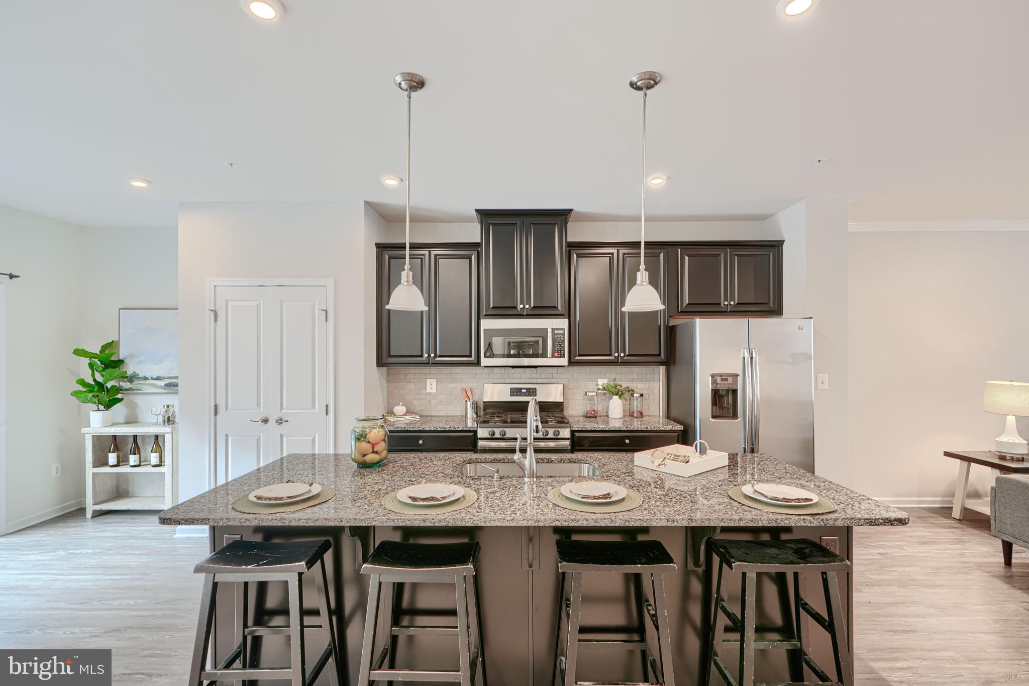 2824 Shaws Road Sparrows Point, MD 21219 - Photo 13 of 61 a kitchen with appliances cabinets dining table and chairs