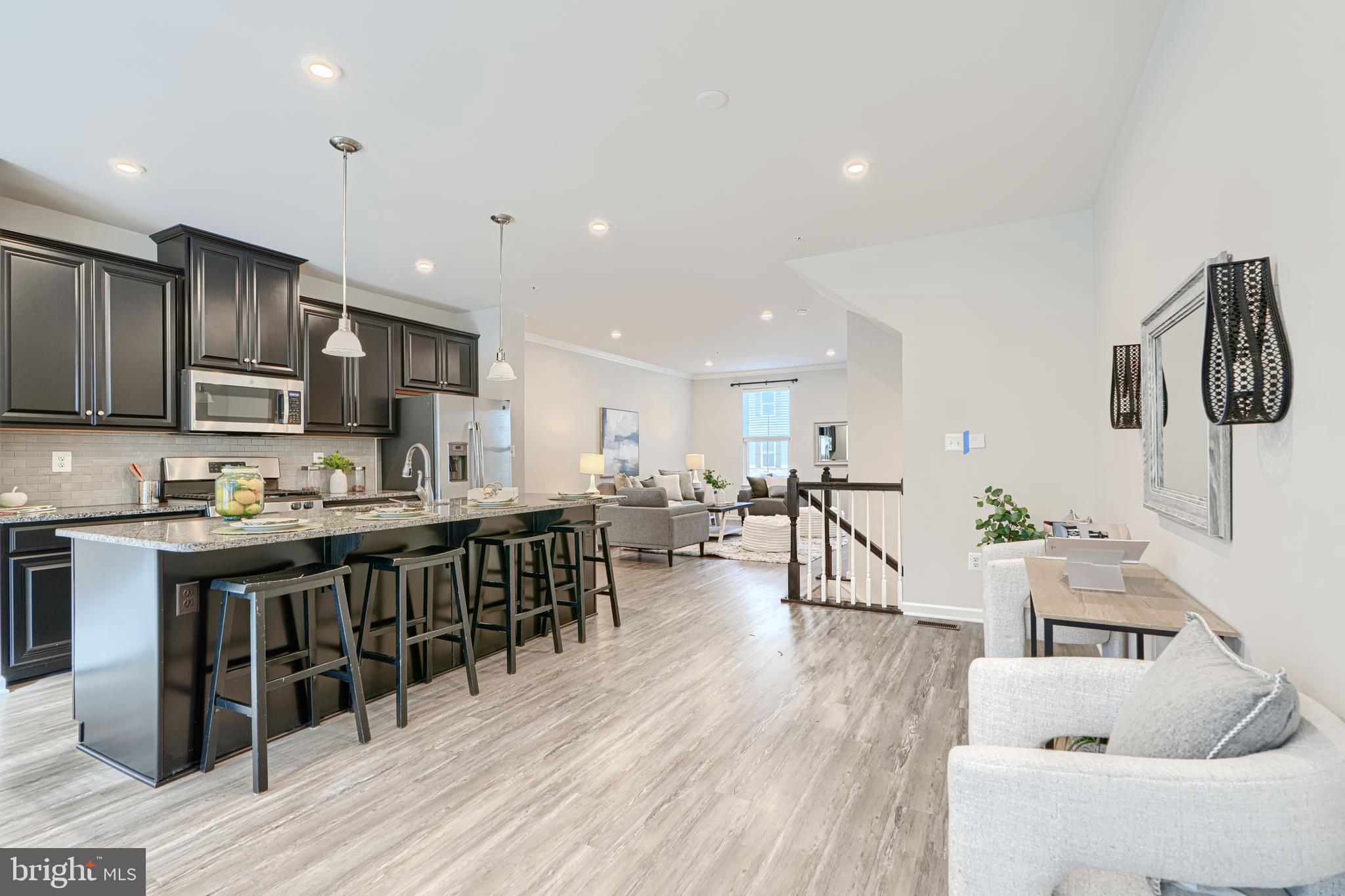2824 Shaws Road Sparrows Point, MD 21219 - Photo 15 of 61 a living room with stainless steel appliances furniture wooden floor and a view of kitchen