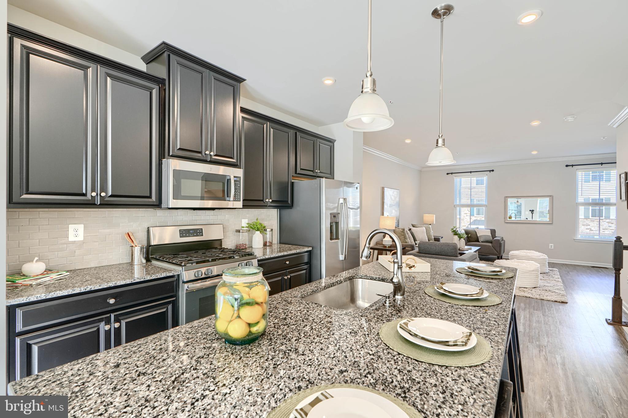 2824 Shaws Road Sparrows Point, MD 21219 - Photo 21 of 61 a kitchen with a sink a stove and chairs