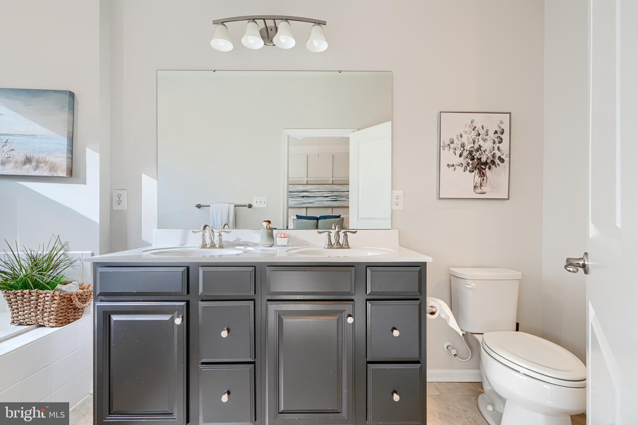 2824 Shaws Road Sparrows Point, MD 21219 - Photo 43 of 61 a bathroom with a toilet a sink and mirror