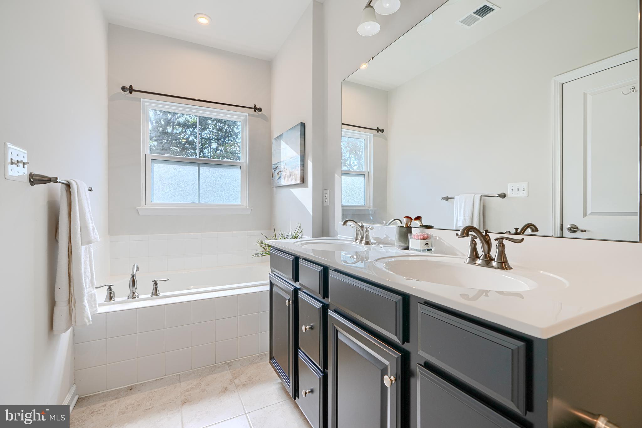 2824 Shaws Road Sparrows Point, MD 21219 - Photo 44 of 61 a bathroom with a granite countertop sink mirror and a bathtub