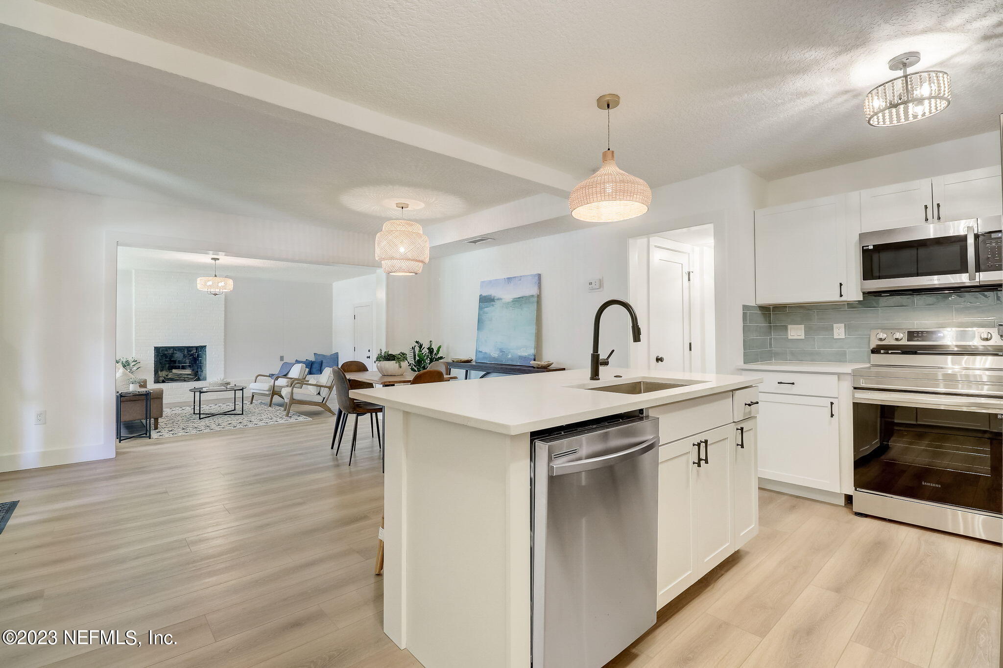 1706 Sunset Drive Jacksonville Beach, FL 32250 - Photo 11 of 44 a kitchen with sink stove and cabinets