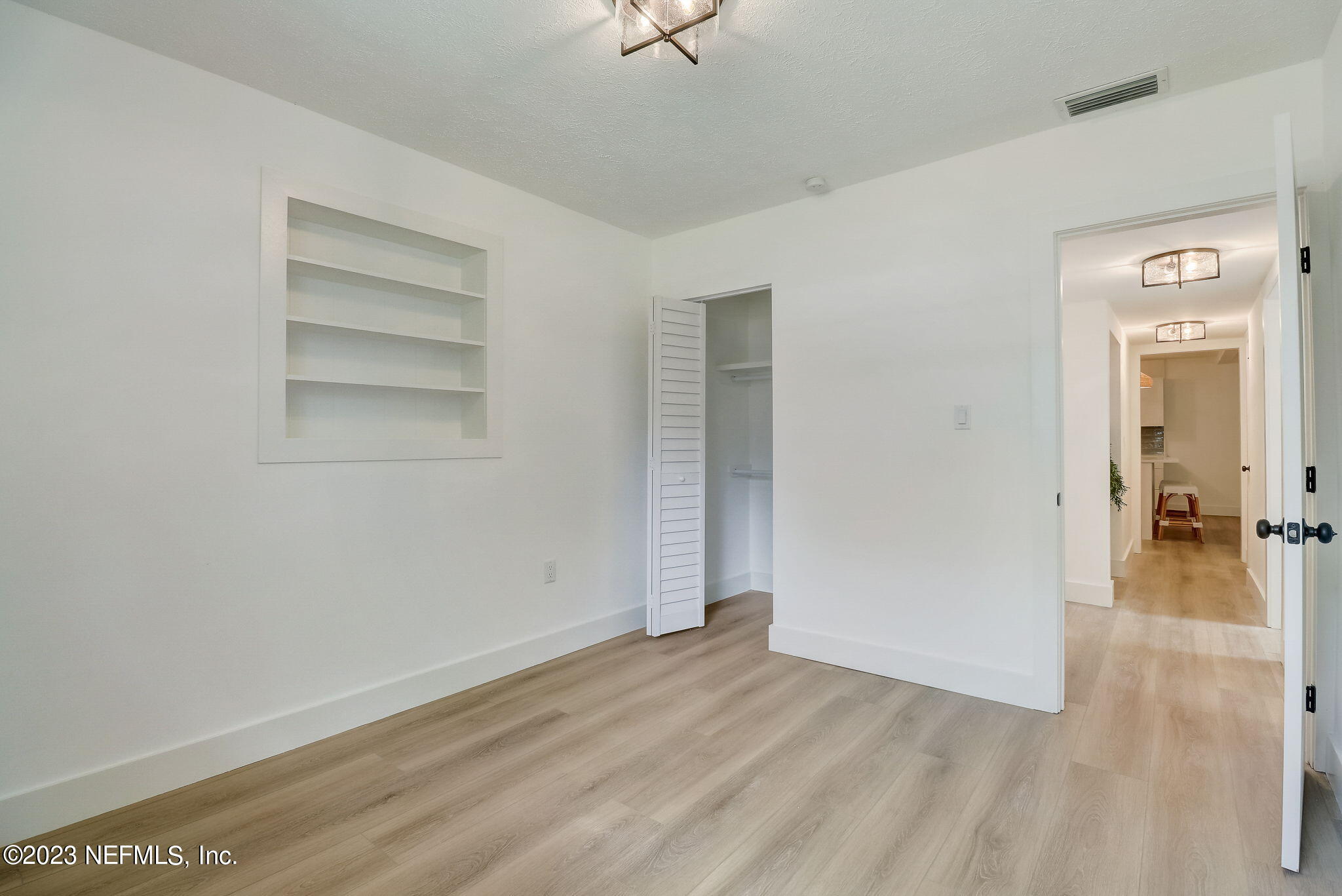 1706 Sunset Drive Jacksonville Beach, FL 32250 - Photo 20 of 44 an empty room with wooden floor and closet