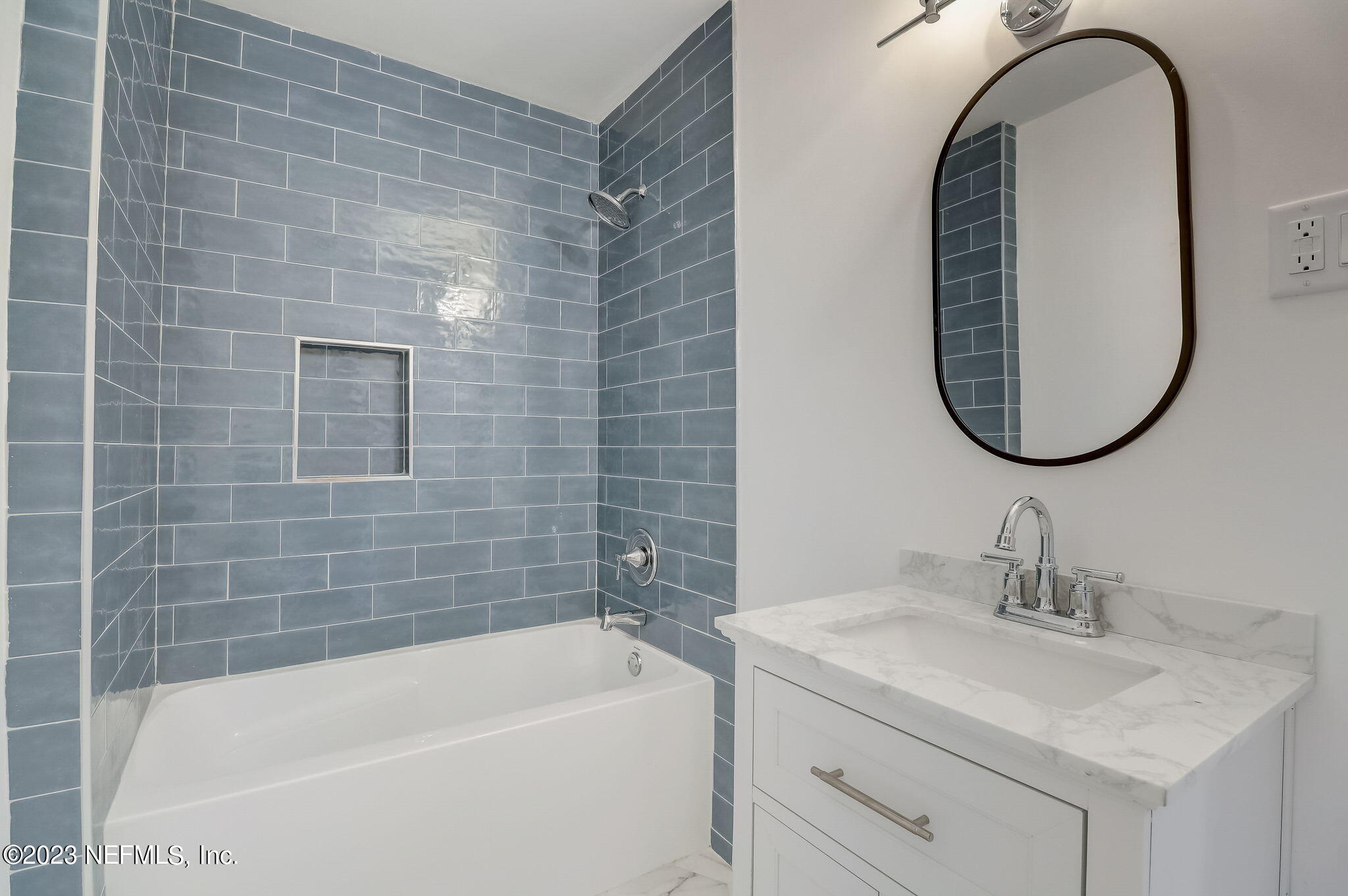 1706 Sunset Drive Jacksonville Beach, FL 32250 - Photo 22 of 44 a bathroom with a sink and a mirror