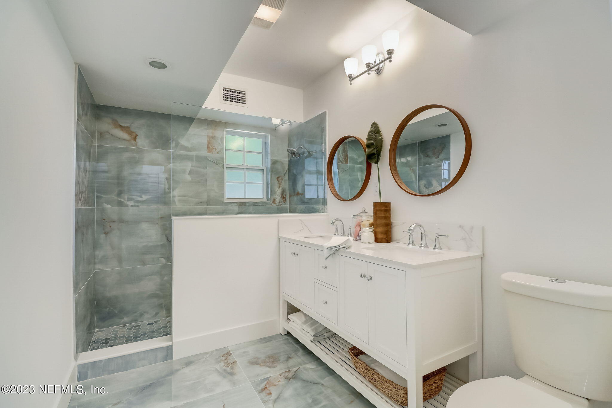 1706 Sunset Drive Jacksonville Beach, FL 32250 - Photo 28 of 44 a bathroom with a toilet a sink and a mirror