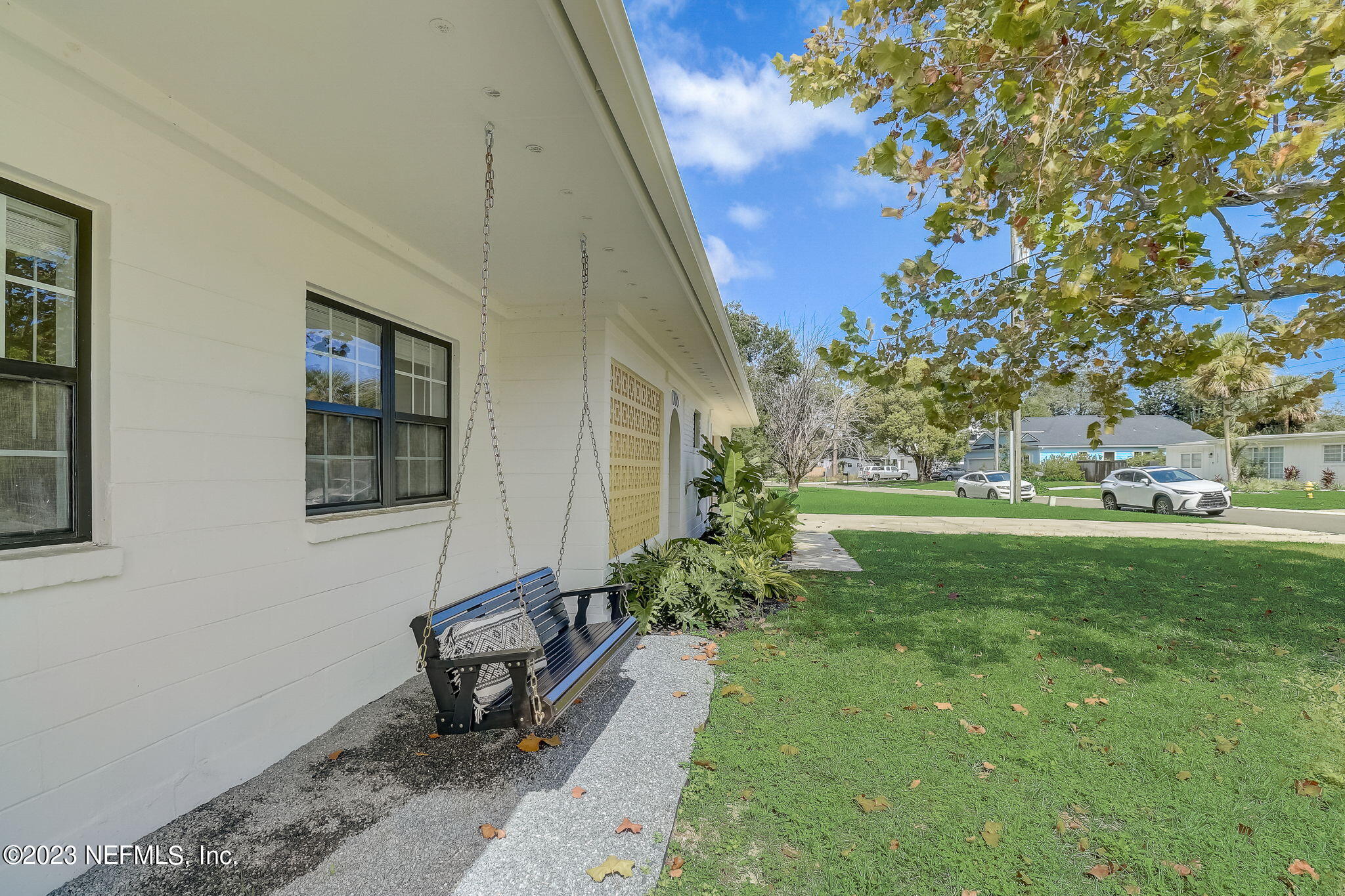 1706 Sunset Drive Jacksonville Beach, FL 32250 - Photo 3 of 44 a garden with trees in front of it
