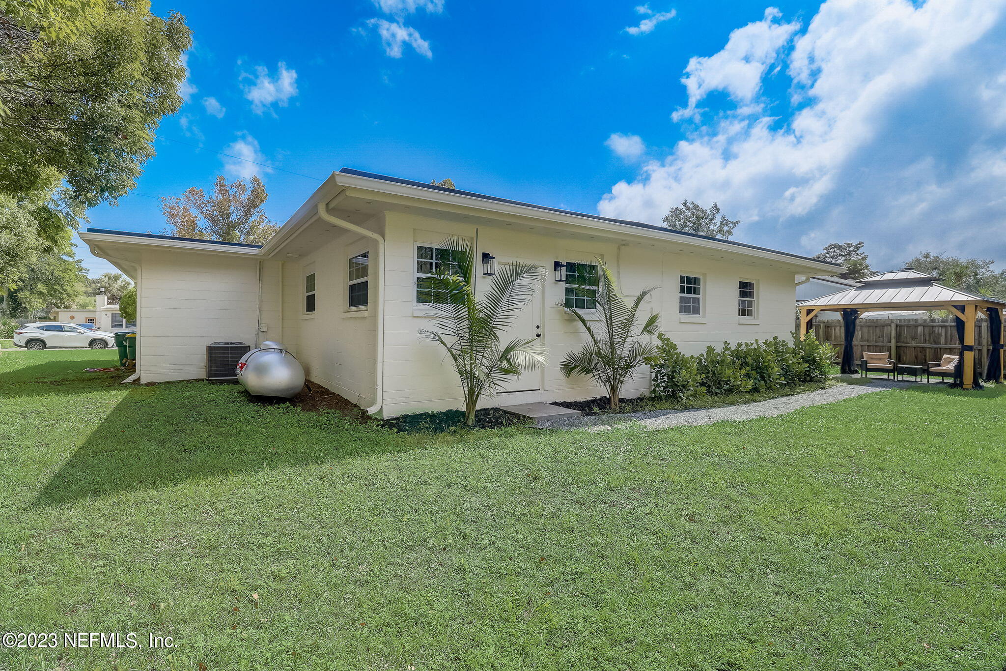 1706 Sunset Drive Jacksonville Beach, FL 32250 - Photo 33 of 44 a backyard of a house with table and chairs