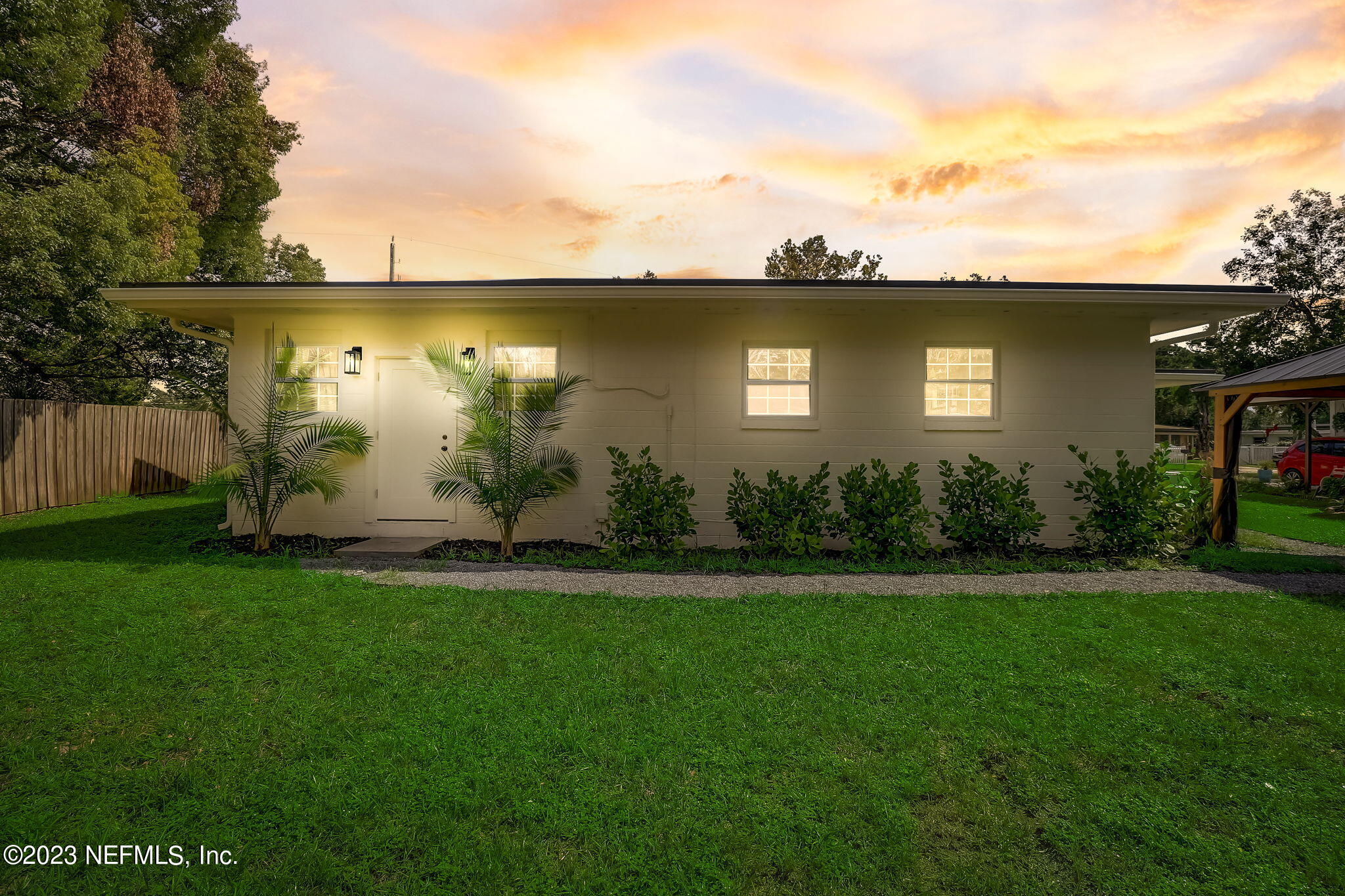 1706 Sunset Drive Jacksonville Beach, FL 32250 - Photo 34 of 44 a view of a yard with a house in the background