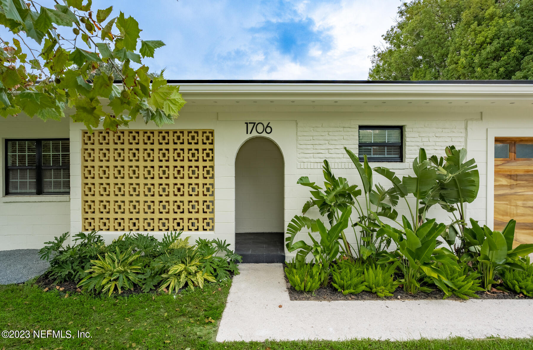 1706 Sunset Drive Jacksonville Beach, FL 32250 - Photo 4 of 44 a front view of a house with garden