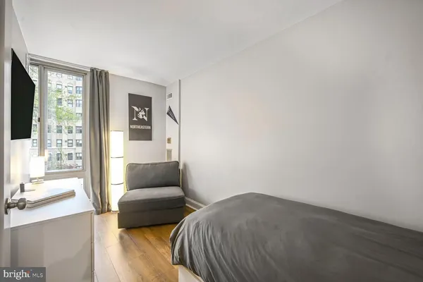 a bedroom with a bed and window