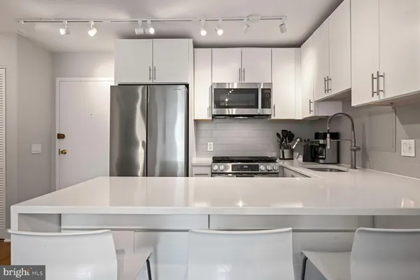 a kitchen with a sink stove and cabinets