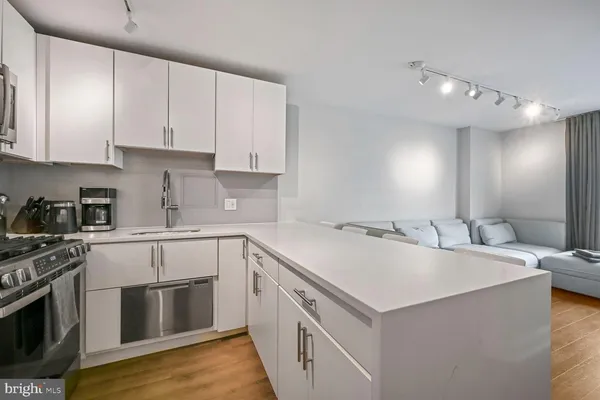 a kitchen with stainless steel appliances granite countertop a sink and a stove