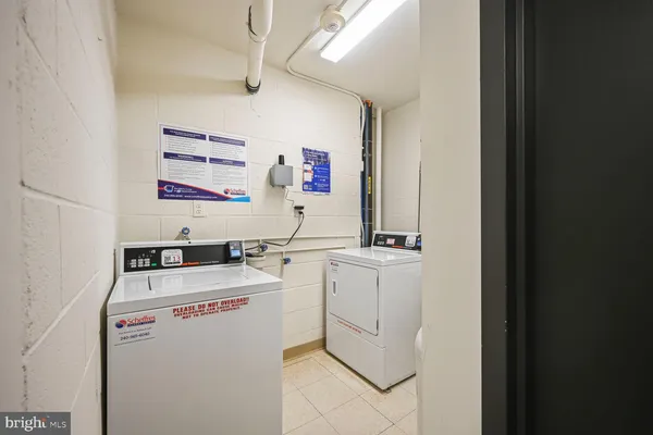 a kitchen with a sink a refrigerator and cabinets