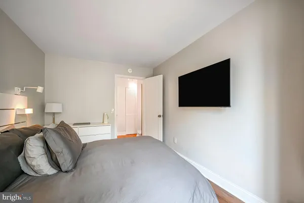 a view of a hallway with wooden floor windows and a livingroom