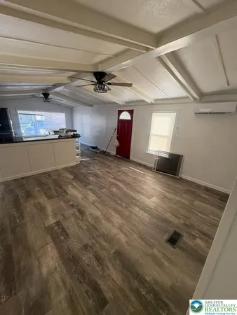 a view of empty room with window and ceiling fan