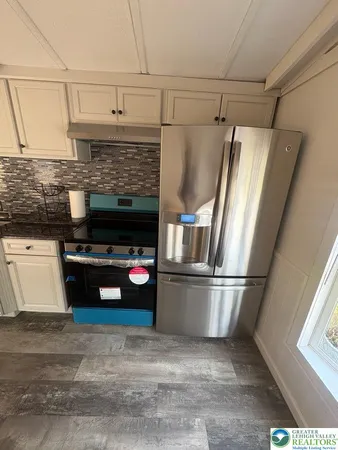 a room with a wooden floor and cabinets