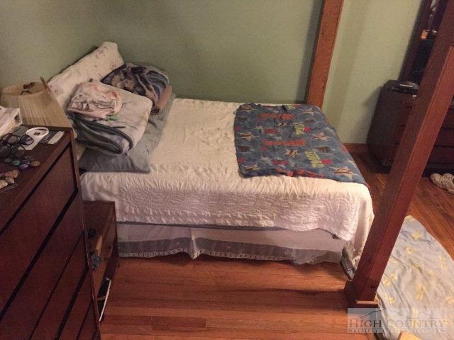 275 Parker Road Creston, NC 28615 - Photo 12 of 31 a bedroom with a bed and a window