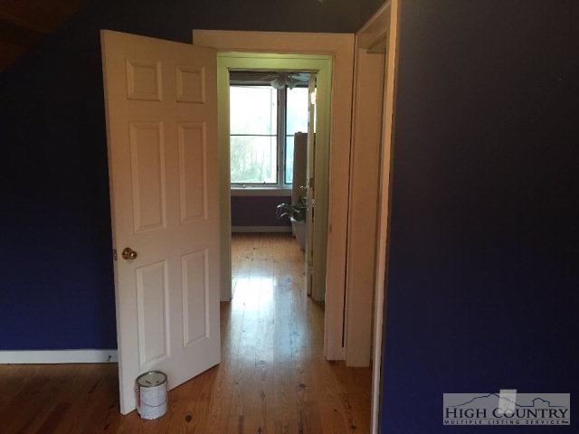 275 Parker Road Creston, NC 28615 - Photo 15 of 31 a view of a hallway with wooden floor