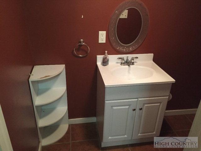 275 Parker Road Creston, NC 28615 - Photo 19 of 31 a bathroom with a sink a toilet and mirror