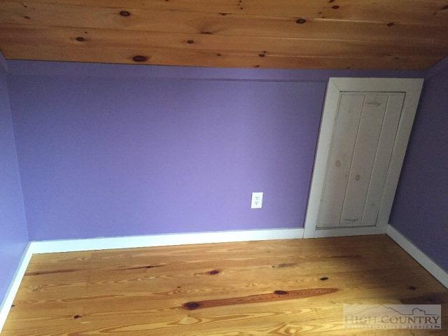 275 Parker Road Creston, NC 28615 - Photo 20 of 31 a view of room with wooden floor