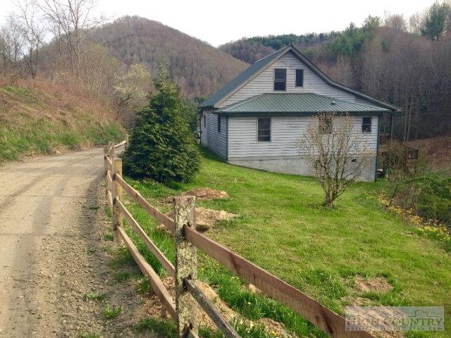 275 Parker Road Creston, NC 28615 - Photo 2 of 31 a front view of a house with garden