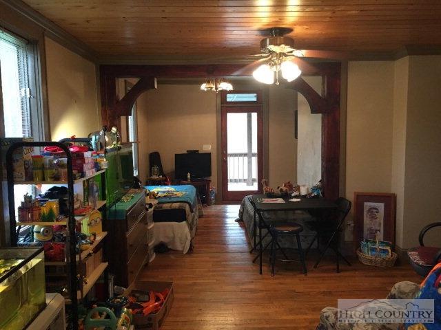 275 Parker Road Creston, NC 28615 - Photo 31 of 31 a bedroom with furniture and a chandelier