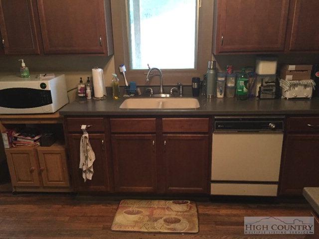 275 Parker Road Creston, NC 28615 - Photo 9 of 31 a kitchen with a sink cabinets and a wooden floor