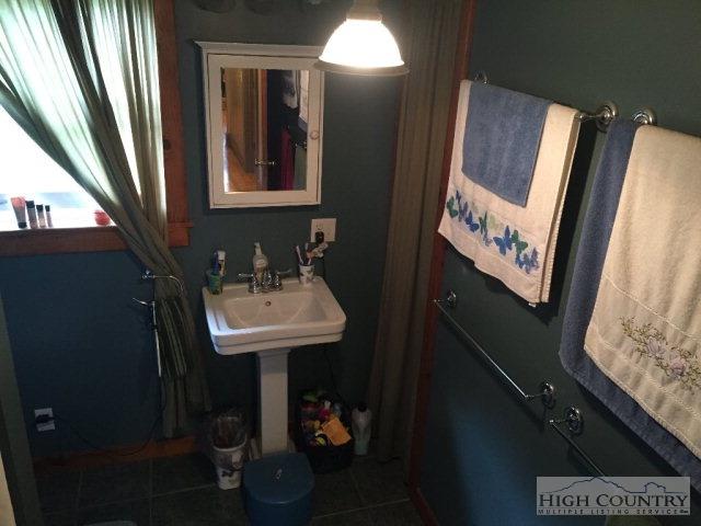 275 Parker Road Creston, NC 28615 - Photo 10 of 31 a bathroom with a sink a mirror and a toilet
