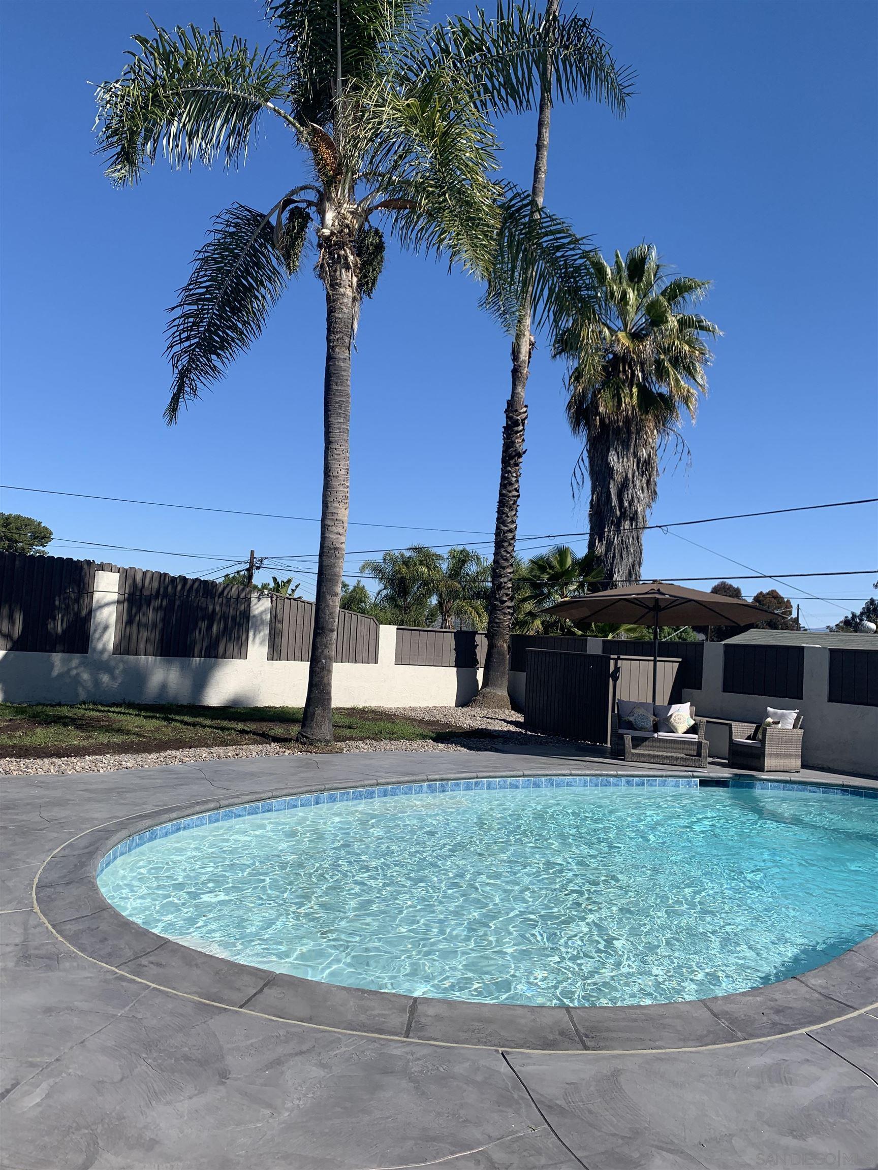 377 El Monte Road El Cajon, CA 92020 - Photo 2 of 19 a view of a swimming pool with a yard