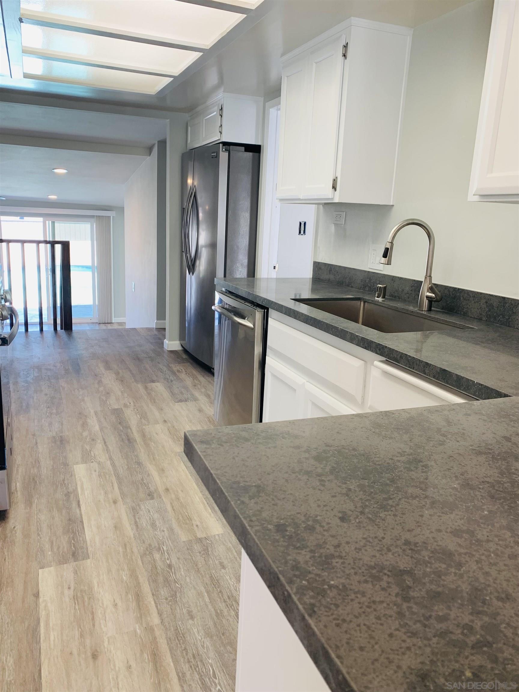 377 El Monte Road El Cajon, CA 92020 - Photo 6 of 19 a kitchen with stainless steel appliances granite countertop a sink stove and cabinets
