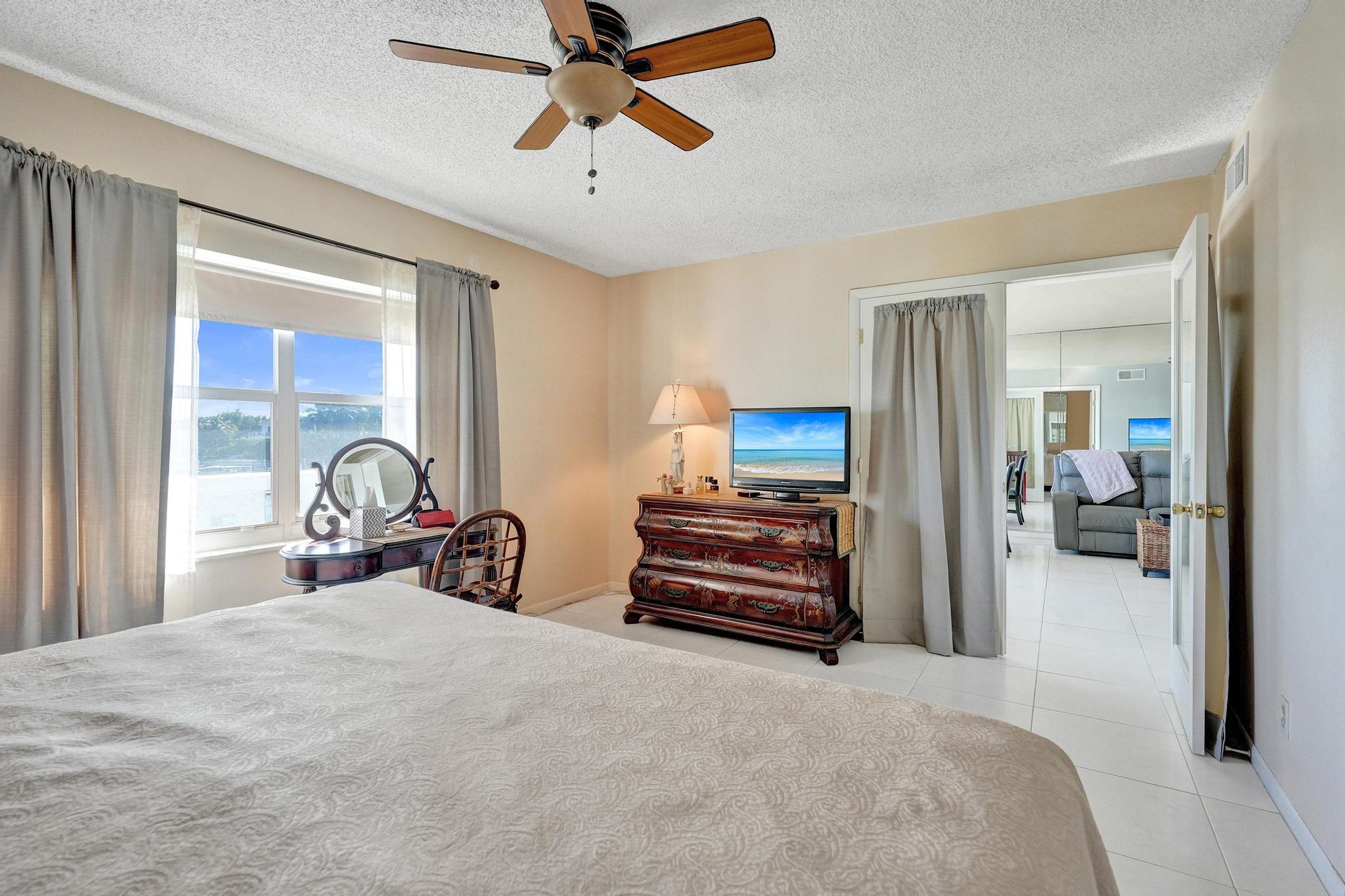 231 East Lantana Road, Unit 204 Lantana, FL 33462 - Photo 13 of 63 a bedroom with furniture and a flat tv screen