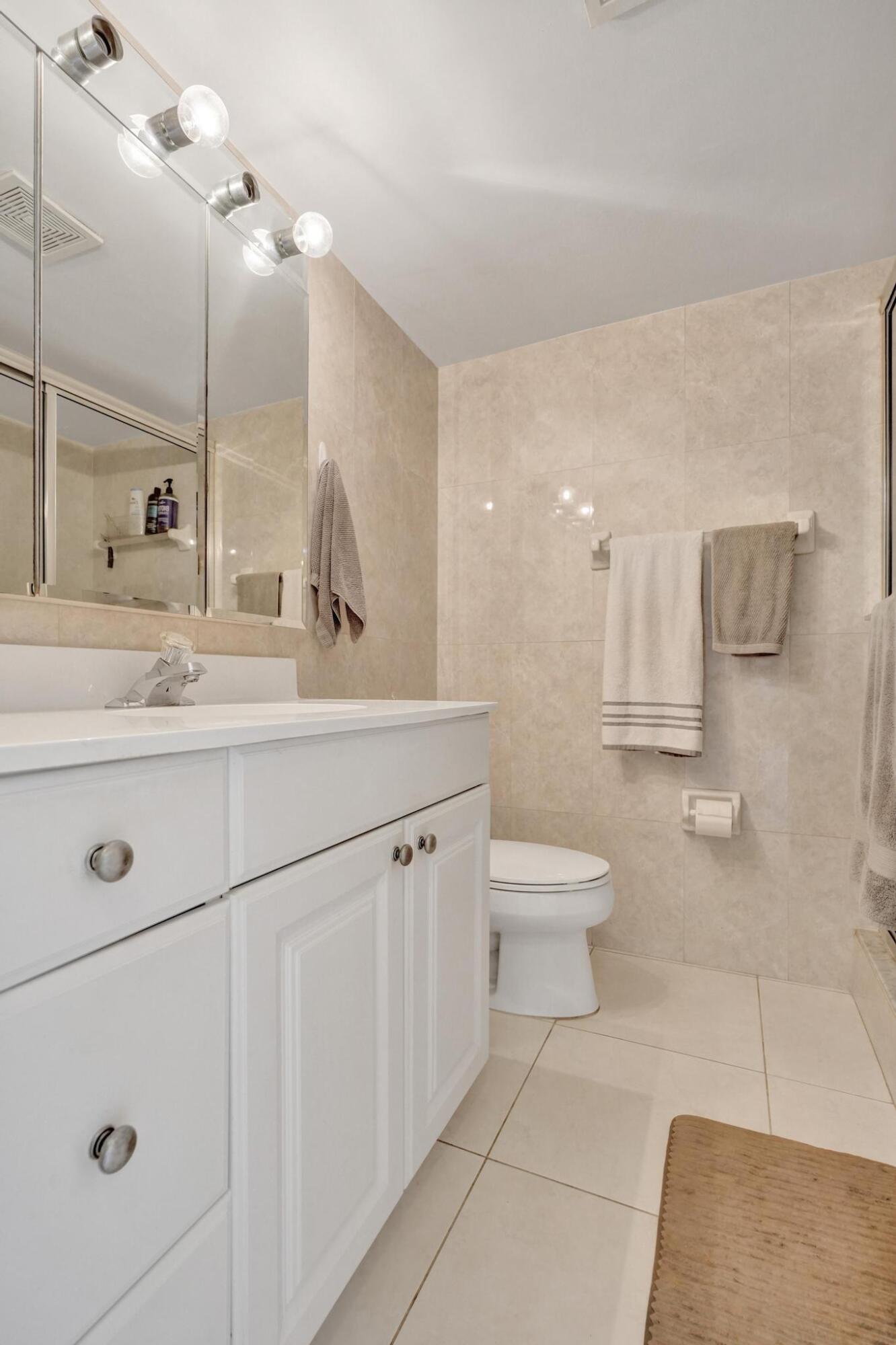 231 East Lantana Road, Unit 204 Lantana, FL 33462 - Photo 16 of 63 a bathroom with a sink a toilet and a mirror