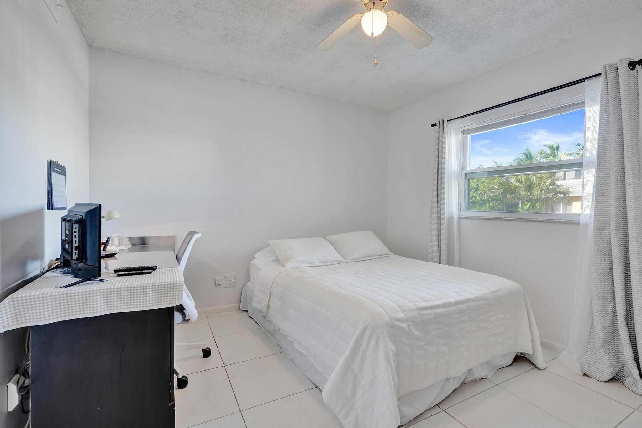 231 East Lantana Road, Unit 204 Lantana, FL 33462 - Photo 20 of 63 a bedroom with a bed window and a desk