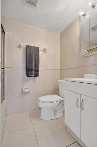 a kitchen with granite countertop a sink cabinets and stainless steel appliances