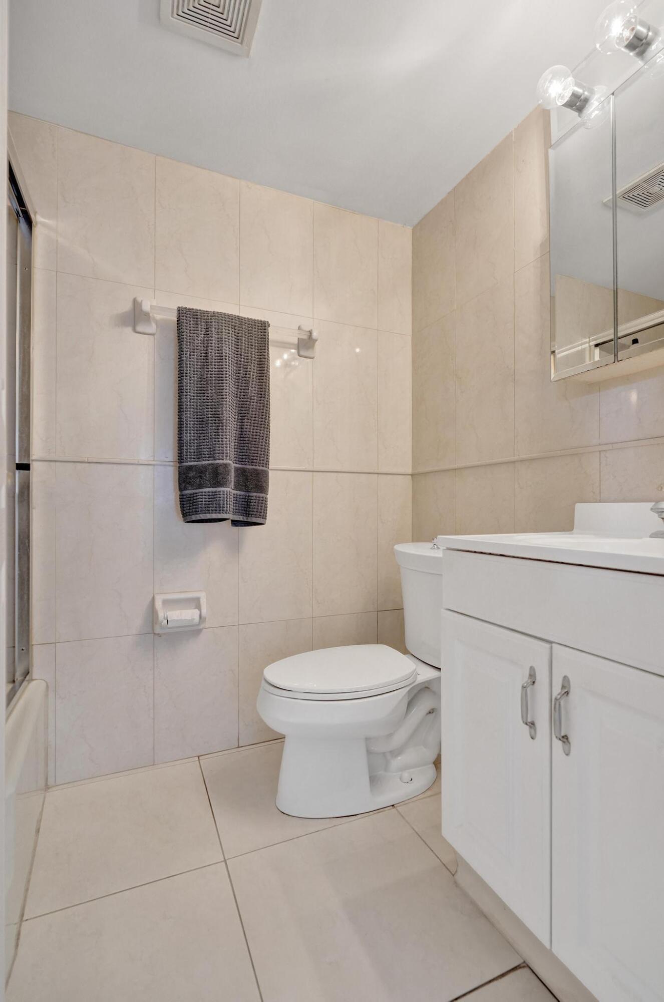 231 East Lantana Road, Unit 204 Lantana, FL 33462 - Photo 26 of 63 a bathroom with a toilet sink and vanity
