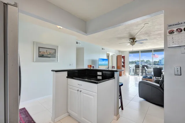 a living room with furniture a chandelier and a flat screen tv