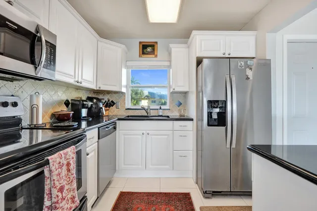 a dining room with furniture and a floor to ceiling window