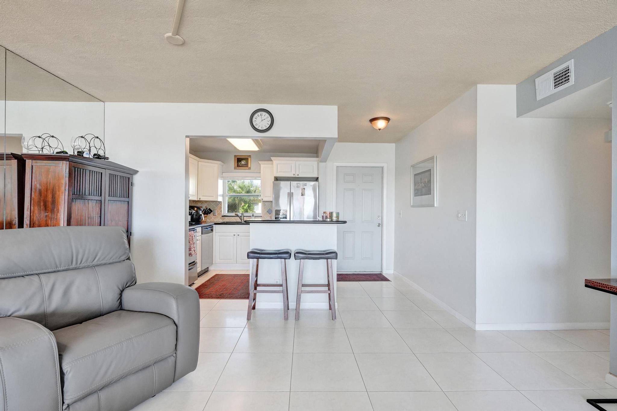 231 East Lantana Road, Unit 204 Lantana, FL 33462 - Photo 34 of 63 a living room with furniture and kitchen view
