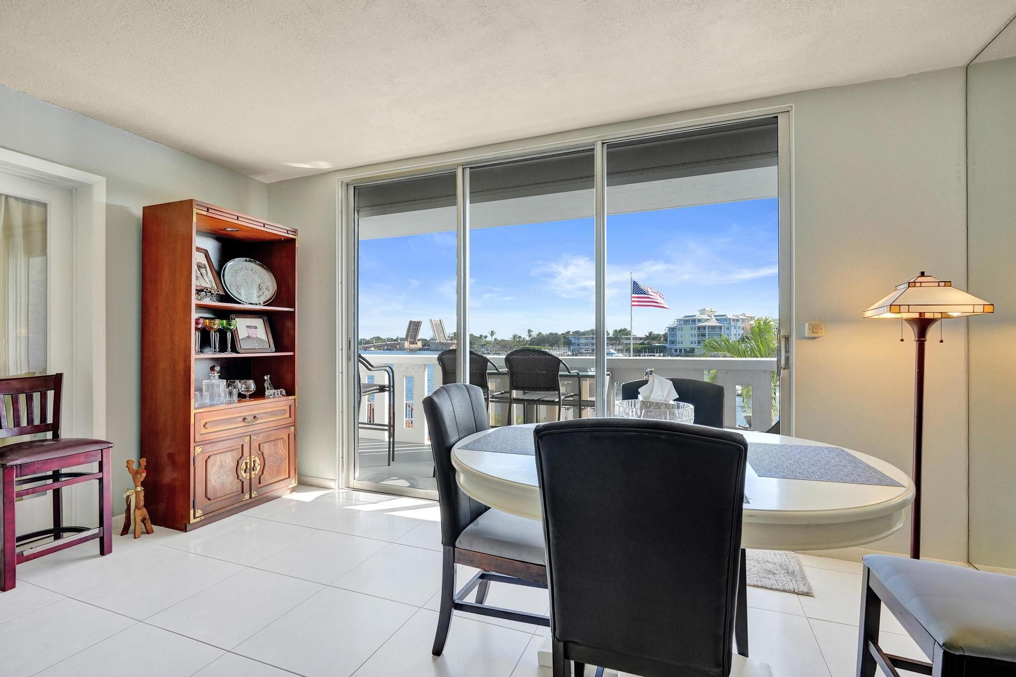 231 East Lantana Road, Unit 204 Lantana, FL 33462 - Photo 39 of 63 a dining room with furniture and a floor to ceiling window