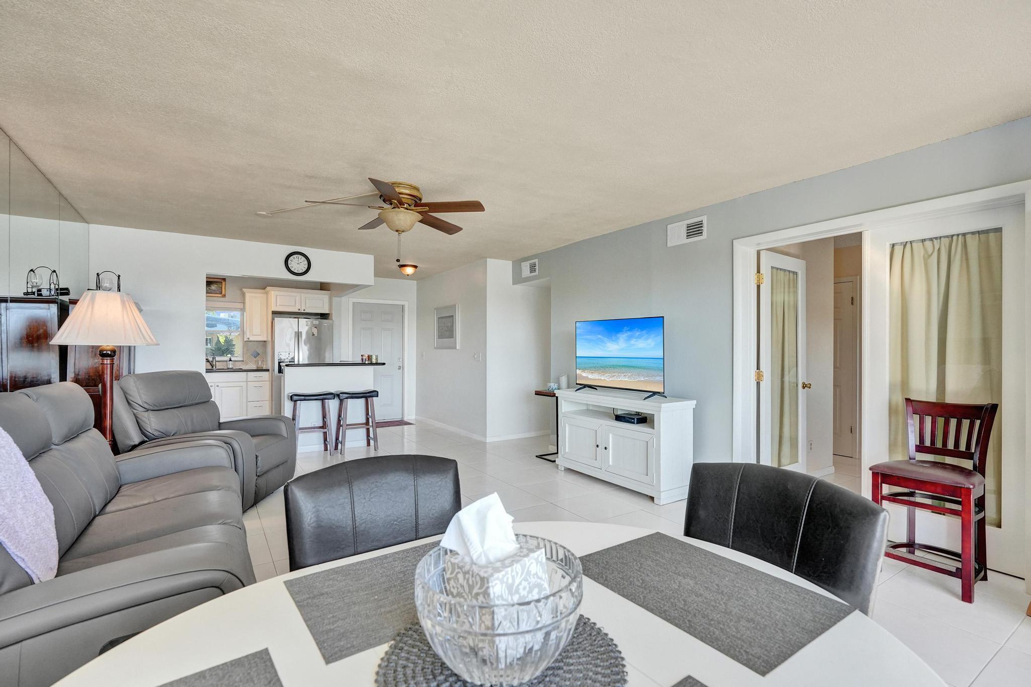 231 East Lantana Road, Unit 204 Lantana, FL 33462 - Photo 41 of 63 a living room with furniture and a wooden floor