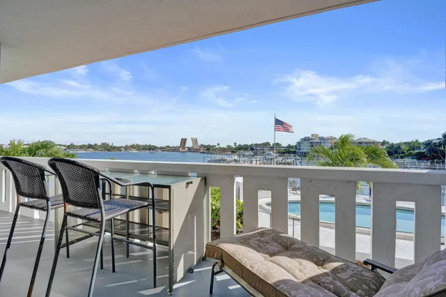 a view of a swimming pool and lounge chairs