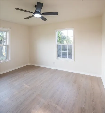 a bathroom with a granite countertop sink a mirror and a bathtub