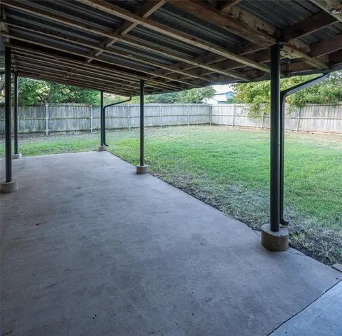 a view of a porch with wooden floor and roof