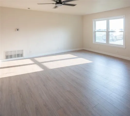 a kitchen with white cabinets and sink