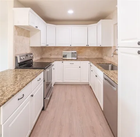 a room with pool table and windows