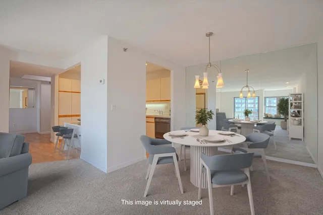 a kitchen with stainless steel appliances a sink a stove and white cabinets