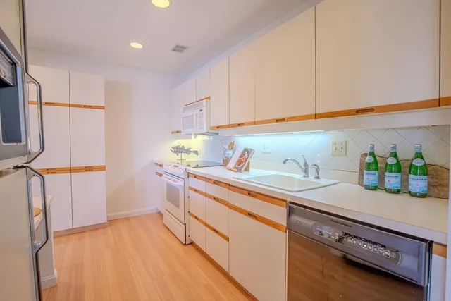 a kitchen that has a lot of cabinets in it
